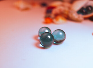 three blue glass balls on a white background