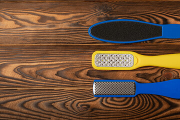 Pedicure tools.Pumice stone and foot file on brown texture background. Close-up. FLAT LAY. Space for text, space for copy.