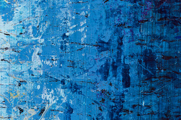 Macro close-up of an abstract blue, white and black acrylic paint background. High resolution full frame textured messy canvas background.