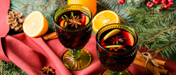 Glasses of tasty mulled wine on table