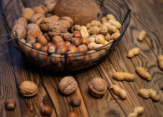 still life with hazelnut peanuts walnut and coconut on wooden board