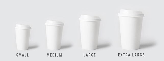 Different sized takeaway coffee cups on light background