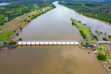 Top view Aerial photo from flying drone over concrete small dam or medium sized dam blocks the Mun River,HUANA DAM Sisaket province,Thailand,ASIA.