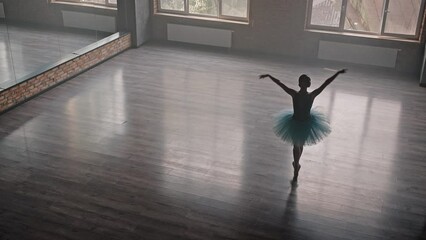 Ballerina in pointe shoes spins around while dancing