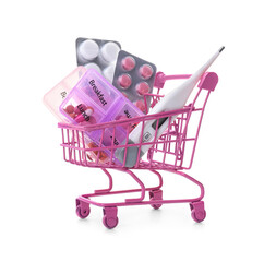 Pink shopping cart with medications on white background