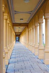 the columns of the walkway in the Hessinpark in Augsburg shine in the golden sunlight