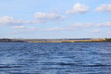 View of beautiful river and bridge on cloudy day