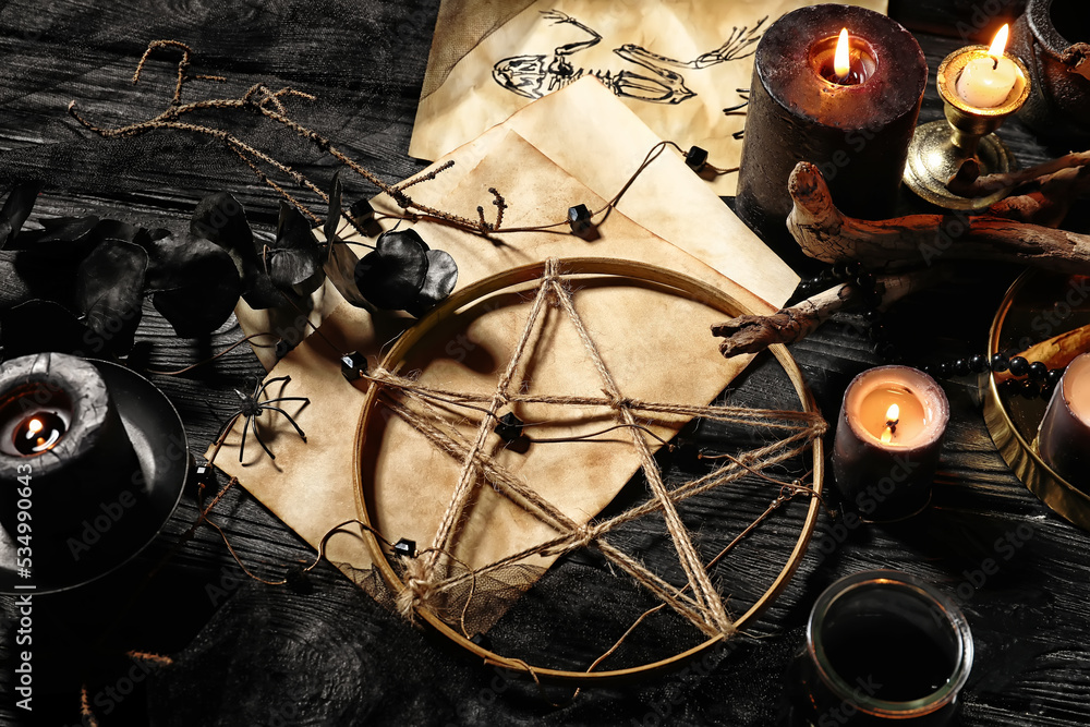 Wall mural magic attributes for ritual on dark wooden wizard table