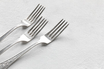 Silver forks on white background, closeup