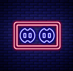 Obraz premium Glowing neon line Electrical outlet icon isolated on brick wall background. Power socket. Rosette symbol. Colorful outline concept. Vector