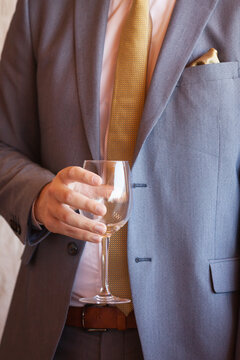 Man In A Suit Holding An Empty Wine Glass