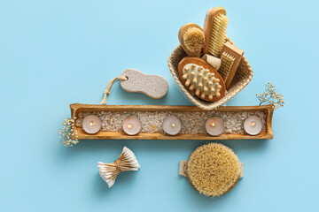Composition with different bath supplies and burning candles on color background