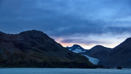 Sunset over a glacier in the mountains near Fortuna Bay, South Georgia Island