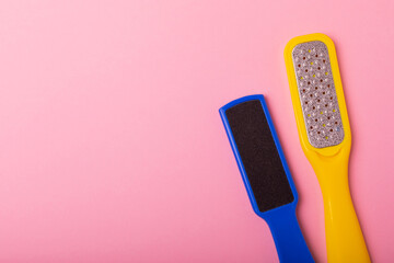 Pedicure tools.Pumice stone and foot file on a pink background. Close-up. FLAT LAY. Space for text,...