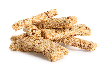 Heap of tasty kozinaki with sesame seeds on white background