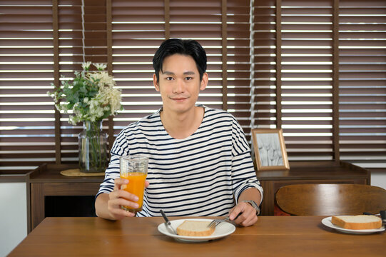 Young smiling asian man having meal on the table, family concept..