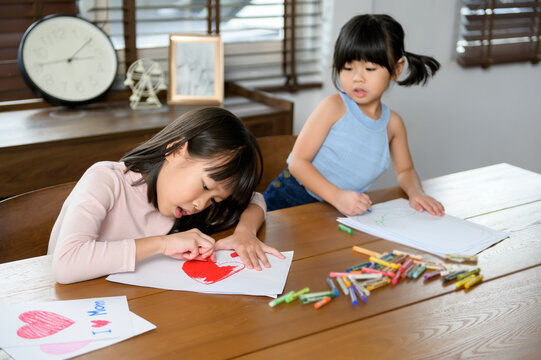 Asian children Drawing and painting on table in playing room at home, Educational game.