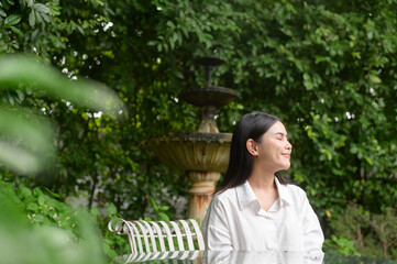 A young healthy woman smiling , refreshing in nature background