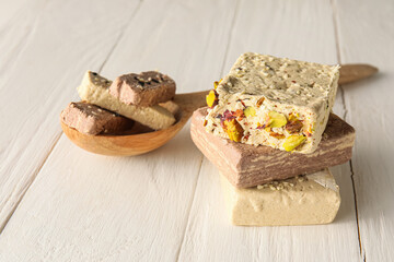 Sweet sesame halva on light wooden background