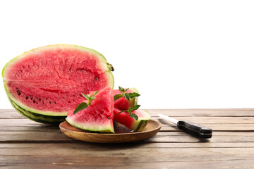 Plate with slices of watermelon, mint and knife on table against white background
