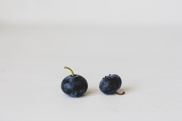 Blueberries on white background with copy space. Two blueberries fruits isolated. Raw food concept. Natural antioxidant concept. Healthy lifestyle. Juicy berries. 