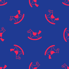 Obraz premium Red Wooden horse in saddle swing for little children icon isolated seamless pattern on blue background. Vector