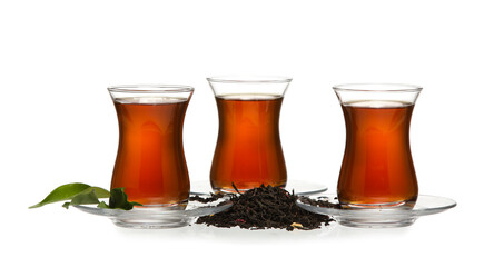Glass cups of hot black tea on white background