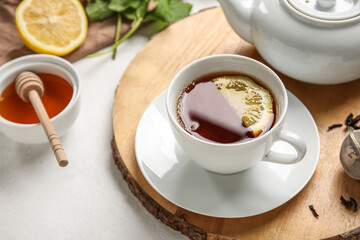 Fototapeta Board with cup of black tea and lemon on white background, closeup obraz