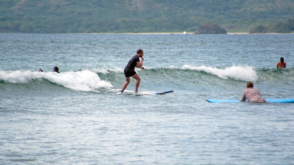 Surfer on the beach in Tamarindo, Costa Rica