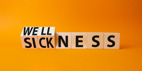 Wellness and Sickness symbol. Turned cubes with words sickness and wellness. Beautiful orange background. Business and wellness and sickness concept. Copy space