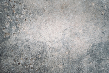 Stony background. Gray concrete texture. Retro wall. Grunge aged surface with damages and holes...