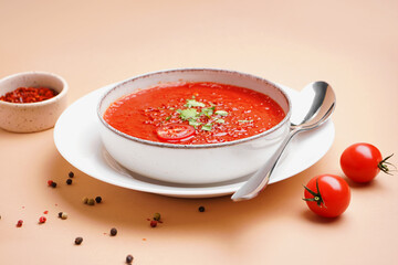 Bowl of tasty tomato soup on color background