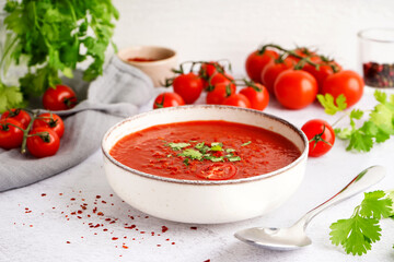 Bowl of tasty tomato soup on light background