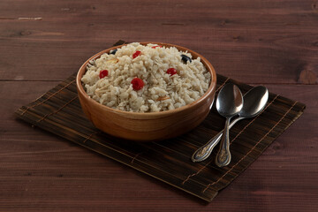 flattened rice isolated on wooden texture background