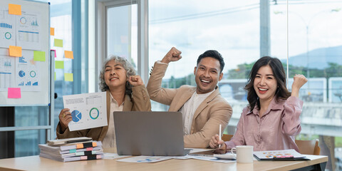 Asian business group of people celebrate while marketing plan mission complete