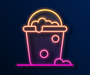 Glowing neon line Bucket with foam and bubbles icon isolated on black background. Cleaning service concept. Vector