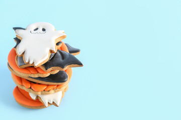 Tasty Halloween cookies on blue background