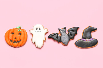 Tasty Halloween cookies on pink background