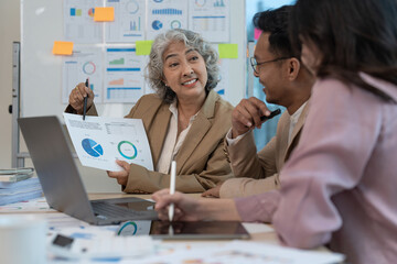 Group of Business people discuss a marketing strategy to improve the quality of their sales in the future at meeting room
