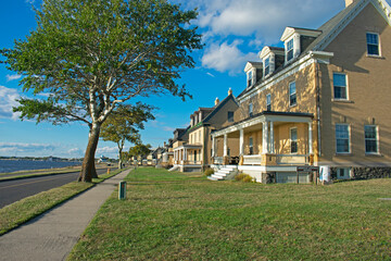 The setting sun shines on a row of damaged buildings being restored at Fort Hancock in Sandy Hook, New Jersey, USA -56