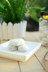 Putri salju cookie is a kind of kue kering from Malaysia which is crescent-shaped and coated with powdered sugar covered like snow. View with copy space.