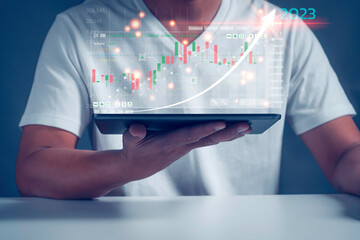 Businessman analysingforex trading graph financial data. Business finance background.Business finance technology and investment concept.2023 business finance technology and investment concept.