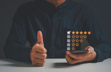 satisfaction concept,man hand thumb up give five stars. with copy space. giving a five star rating. Service rating