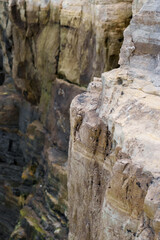 Fototapeta na wymiar The edge of the rock. Cracked cliff