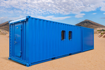 Container change house on sand. Blue steel container with door. Container change house for builders...