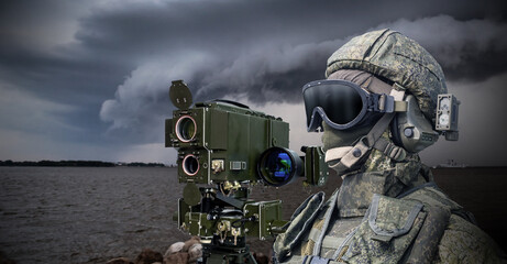 Navy soldier. Laser rangefinder next to soldier. Man in camouflage military uniform. Equipment for naval army. Soldier stands on bank of river. Military technologies. Warrior in face mask and helmet