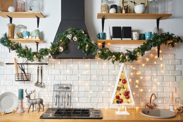 Christmas cozy kitchen room interior with wooden Christmas tree and garland