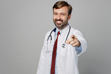 Male doctor man wears white medical gown suit stethoscope work in hospital point index finger camera on you motivating encourage isolated on plain grey color background. Healthcare medicine concept.