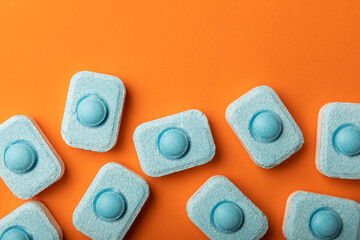 Water softener tablets on orange background
.FLAT LAY. Place for text.Space for copy.Top view....