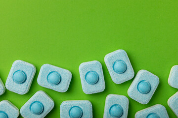 Water softener tablets on green background
.FLAT LAY. Place for text.Space for copy.Top view....